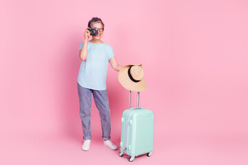 Poster - Full size photo of pretty aged woman suitcase photocamera empty space isolated on pink color background