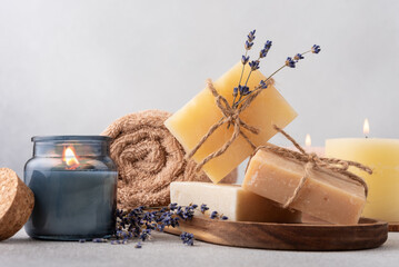 Wall Mural - Cozy spa still life with handcrafted organic soap bars, towel and aroma candles