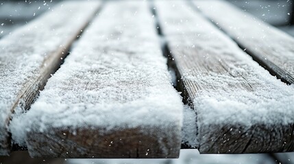 Wall Mural - Textured surface of a snow-covered picnic table, with the wood grain partially visible under the snow. 4K hyperrealistic photo.