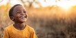 © Danko - Young african boy enjoying a cheerful. Carefree. And delightful day. Displaying genuine laughter and bright smiles.
