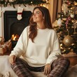 © Alena - Young female model in oversized sweatshirt mockup with Christmas cozy room background. Woman in basic natural long sleeve shirt. Women's Gildan, front view. Normal pullover, winter casual jumper