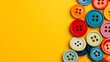 © BozStock - Multicolored buttons on a yellow background.