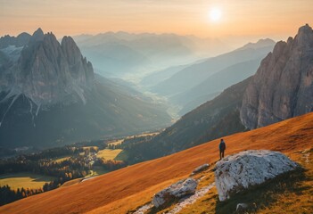 Man on stone on the hill and beautiful mountain valley in haze at colorful sunset in autumn. Dolomites, Italy. Guy, mountain ridges in fog, orange grass and trees. Ai generated image.