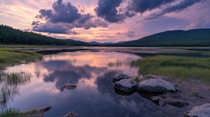 Poster - A serene landscape at sunset, reflecting clouds and mountains in a tranquil lake.