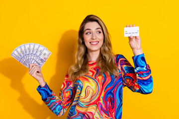 Canvas Print - Photo portrait of lovely young lady look credit card hold money fan dressed stylish colorful garment isolated on yellow color background