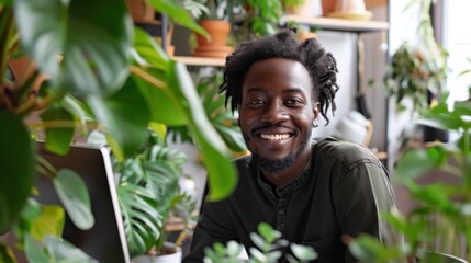 Fototapete - A man with a beard and dreadlocks is smiling in front of a plant