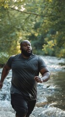 Poster - A man is running in a stream with his shirt wet