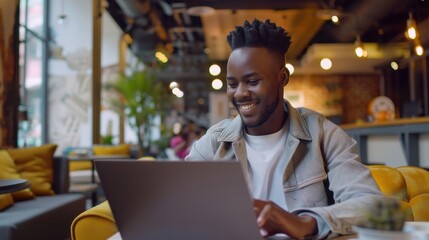 Aufkleber - A young man is sitting on a couch with a laptop in front of him