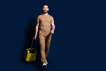 Canvas Print - Photo portrait of mature age positive smiling man in beige t shirt flight going with baggage isolated on dark blue color background