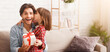 © Prostock-studio - Beautiful preschool girl greeting her daddy with Father Day, daughter kissing dad, impressed man holding gift box, home interior, copy space