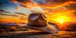© Achiraya - Rugged cowboy hat silhouette stands prominently against a vibrant sunset backdrop, evoke a sense of freedom and
