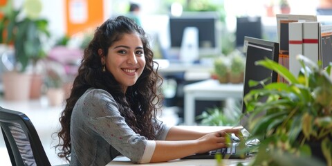 Professional business woman learning and writing financial report by using computer while sitting at modern office. Attractive smart female leader looking marketing strategy while typing plan. AIG51.