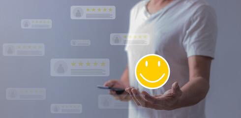 Experience;  Review, Young Man using smartphone mobile hand holding emoji to review and give 5 stars with very good results in service, Good review 5 star rating choice feedback