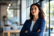 © Ibnu - Confident Businesswoman Standing in Office with Arms Crossed
