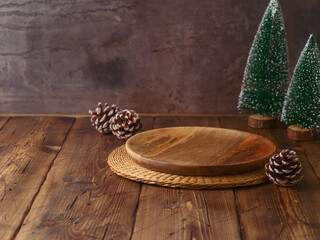 Canvas Print - Empty wooden plate on table with Christmas decorations over dark background. Christmas holiday mock up for design and product display