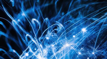 dazzling blue and silver fireworks exploding against night sky creating intricate patterns of sparks and light trails to celebrate new years eve