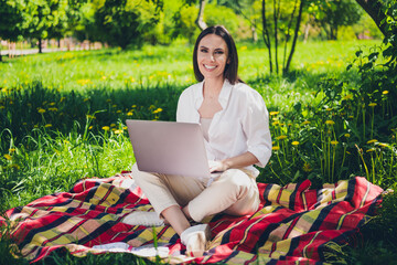 Canvas Print - Full size photo of attractive young cheerful girl sit picnic plaid blanket work netbook wear white garment having fun outside outdoors