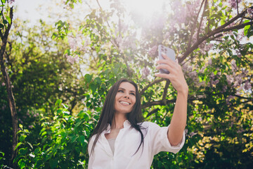 Poster - Photo of young cheerful woman take selfie photo wear white outfit walk park sunny summer weather outside