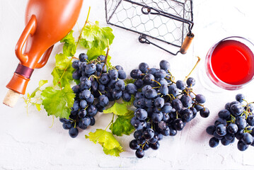 Wall Mural - Black grapes and leaves on a table