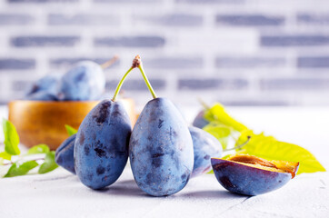 Wall Mural - Plum fruit on white table