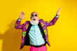 © deagreez - Portrait of overjoyed aged man star shape sunglass enjoy dancing isolated on yellow color background