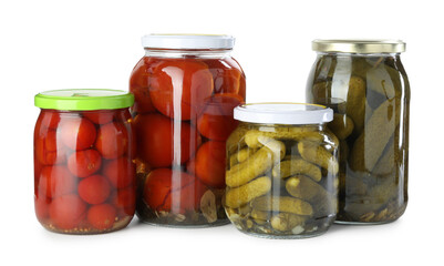 Wall Mural - Tasty pickled tomatoes and cucumbers in jars isolated on white