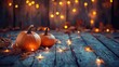 © ShinneProject - Two small pumpkins with fall leaves and string lights on a wooden surface.
