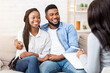 © Prostock-studio - Happy black couple sitting in counselor's office after successful marital therapy, copy space
