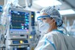 © Tanu - A healthcare worker in full protective gear observes vital signs on a monitor in an intensive care unit, focused on patient care and safety in a hospital environment.