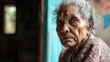 © Lakkhana - Elderly woman in a rural clinic, facing health disparities, concerned look, clinical background