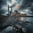 © Colin - A power plant by the river, with smoke rising from its chimney into dark clouds, creating a dramatic, symmetrical scene.