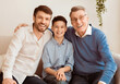 © Prostock-studio - Joyful Grandpa With Mature Son And Little Grandson Smiling At Camera Posing Sitting On Couch Indoor. Male Generation Concept.