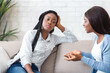 © Prostock-studio - Indifference in friendship. Bored black girl tired of listening her talkative girlfriend while sitting on sofa at home together