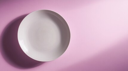 Photograph of a simple ceramic white plate against an isolated soft lilac background. 