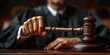 © YuDwi Studio - Judge's Hand Holding Gavel in Courtroom