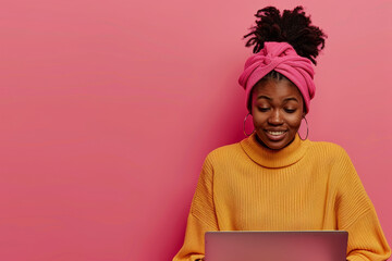 Sticker - A woman wearing a yellow sweater and pink scarf is sitting in front of a laptop