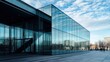 © Supriyanto - Modern glass building reflecting the sky and surroundings, showcasing contemporary architecture.