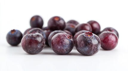 A close-up of fresh blueberries arranged on a white surface.