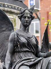 A statue of a woman with wings on her back