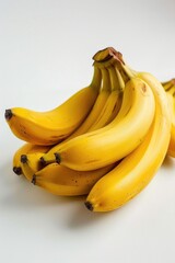 Poster - A bunch of ripe bananas sitting on a wooden table, ready for use or decoration