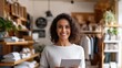 © Business Image - Confident woman smiling with tablet in modern retail clothing store