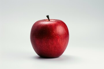 Wall Mural - A single red apple sits atop a clean white surface