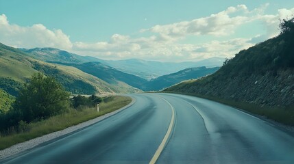 Wall Mural - Curved road stretching endlessly toward distant scenery picture