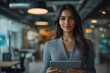 © Aliaksandra - female entrepreneurship, an indian female entrepreneur showcasing leadership and innovation in a modern office by presenting with a digital tablet