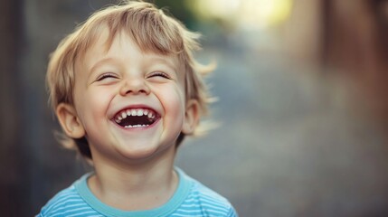 Portrait of adorable toddler boy laughing outdoors