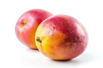 two ripe mangoes sit side by side, perfect for a snack or decoration