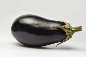 Poster - A close-up of a single eggplant sitting on a clean white background, perfect for food and recipe illustrations