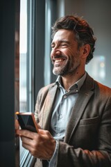 Canvas Print - A person smiling while looking at their mobile device