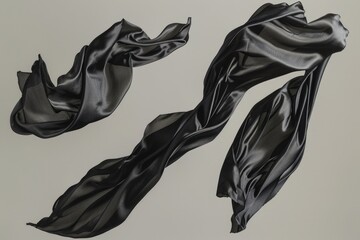 Poster - A pair of luxurious black silk scarves lying flat on a clean white surface, perfect for decorating or styling