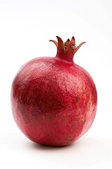 Poster - A juicy red pomegranate sitting on a clean white surface
